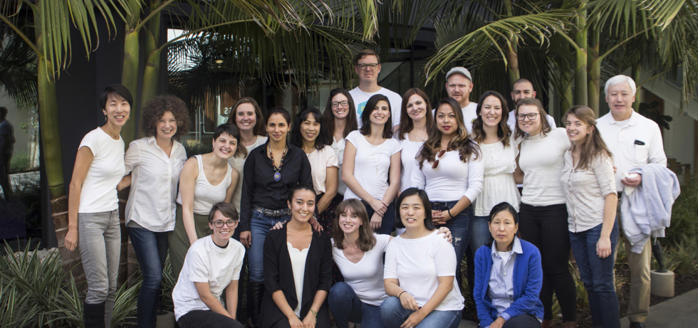 The Technovation team poses for a photo in front of palm trees